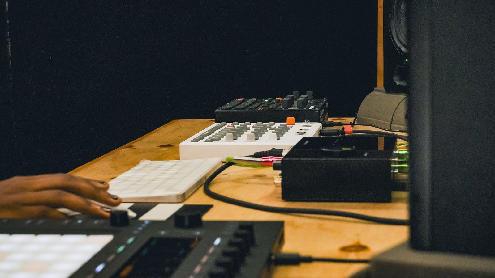 Controllers, a keyboard and a drum machine set up on a desk in the Santuri studio