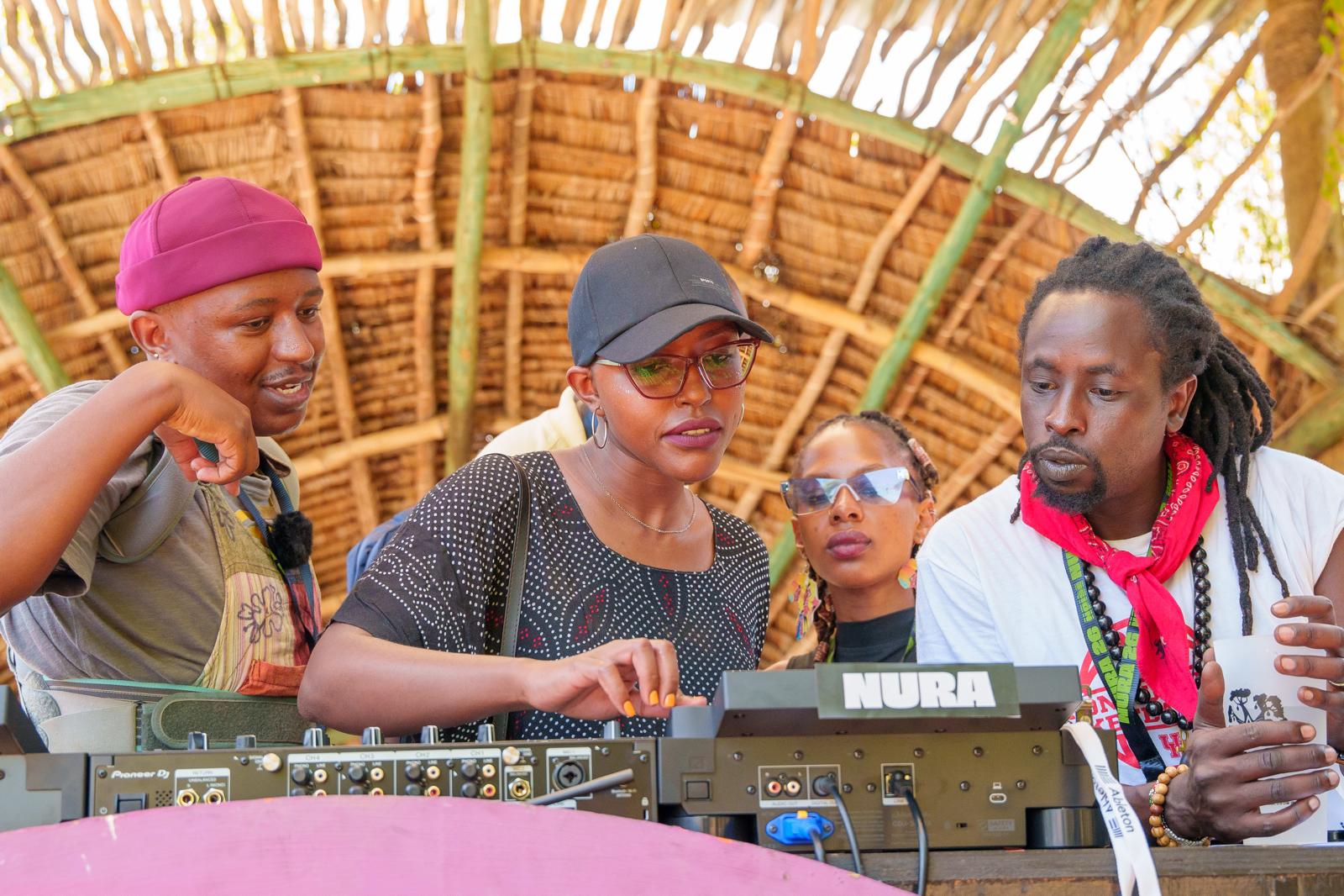 Participants practising together on CDJ decks at a NURA x JCK session